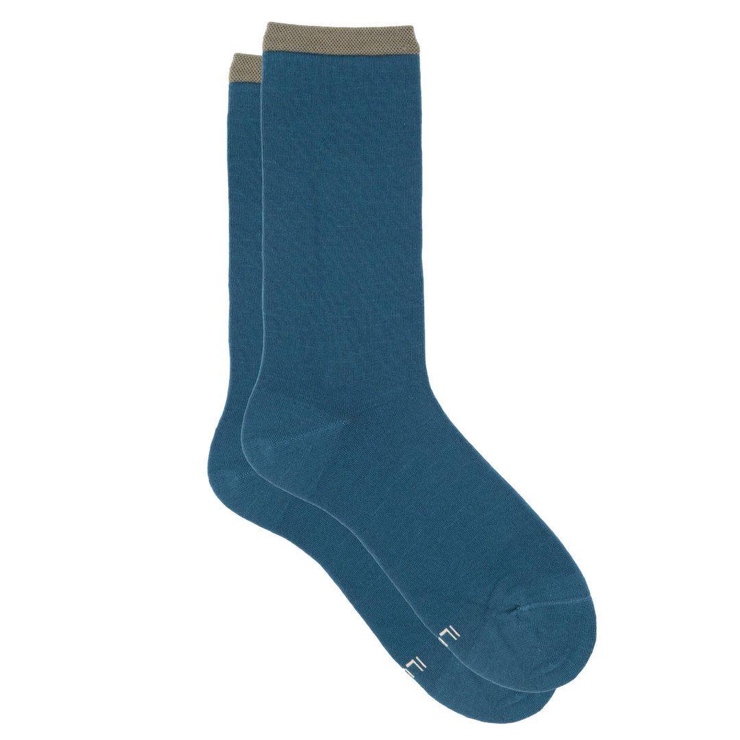 Pair of teal socks with a white logo on a white background