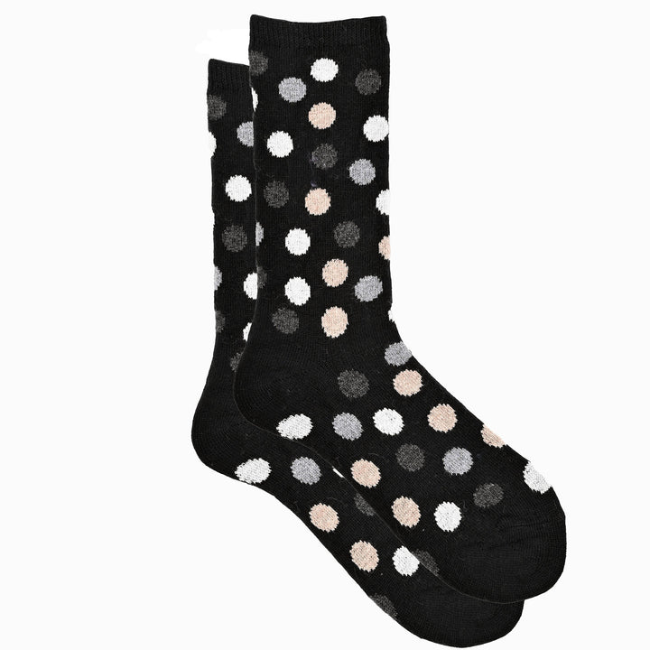 A pair of black crew socks with a multicolored dot pattern.