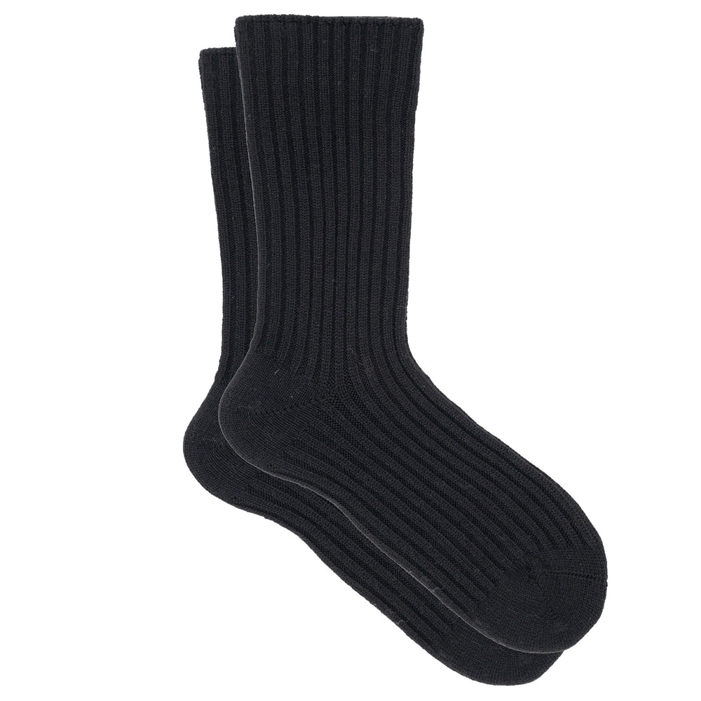 A pair of black ribbed crew socks made from a cashmere, silk, and tencel blend.