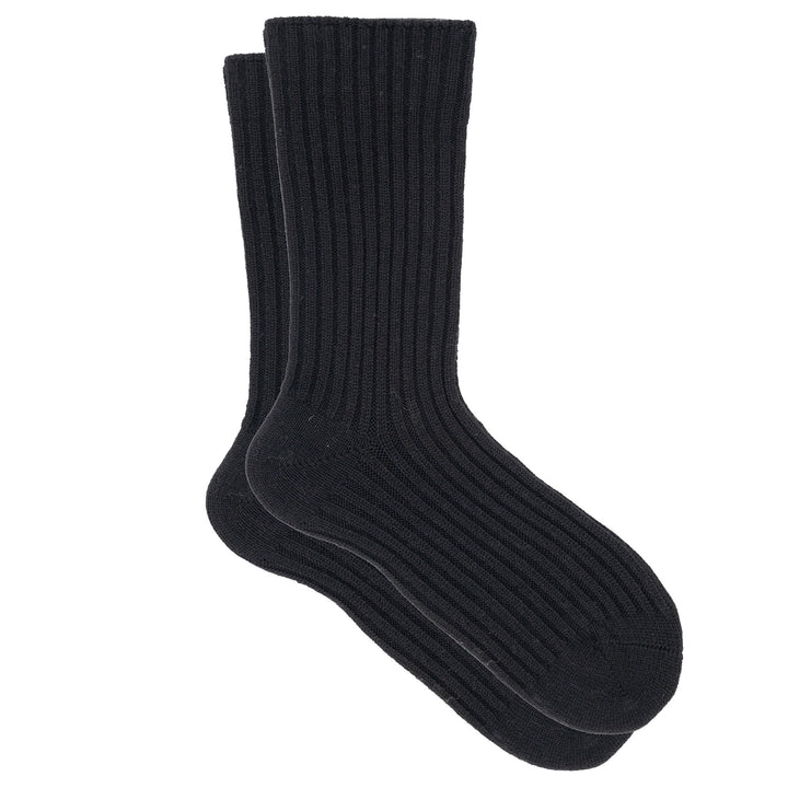 A pair of black ribbed crew socks made from a cashmere, silk, and tencel blend.