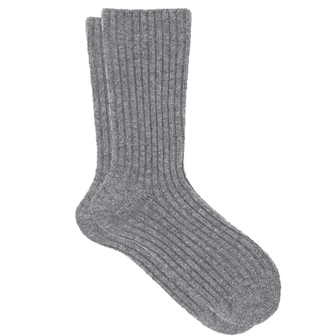 A pair of gray ribbed crew socks made from a cashmere, silk, and tencel blend.