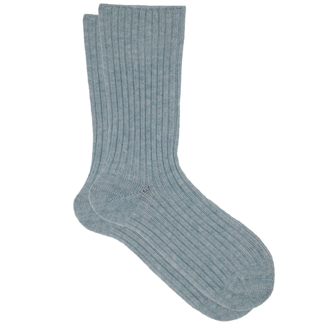 A pair of blue ribbed crew socks made from a cashmere, silk, and tencel blend.