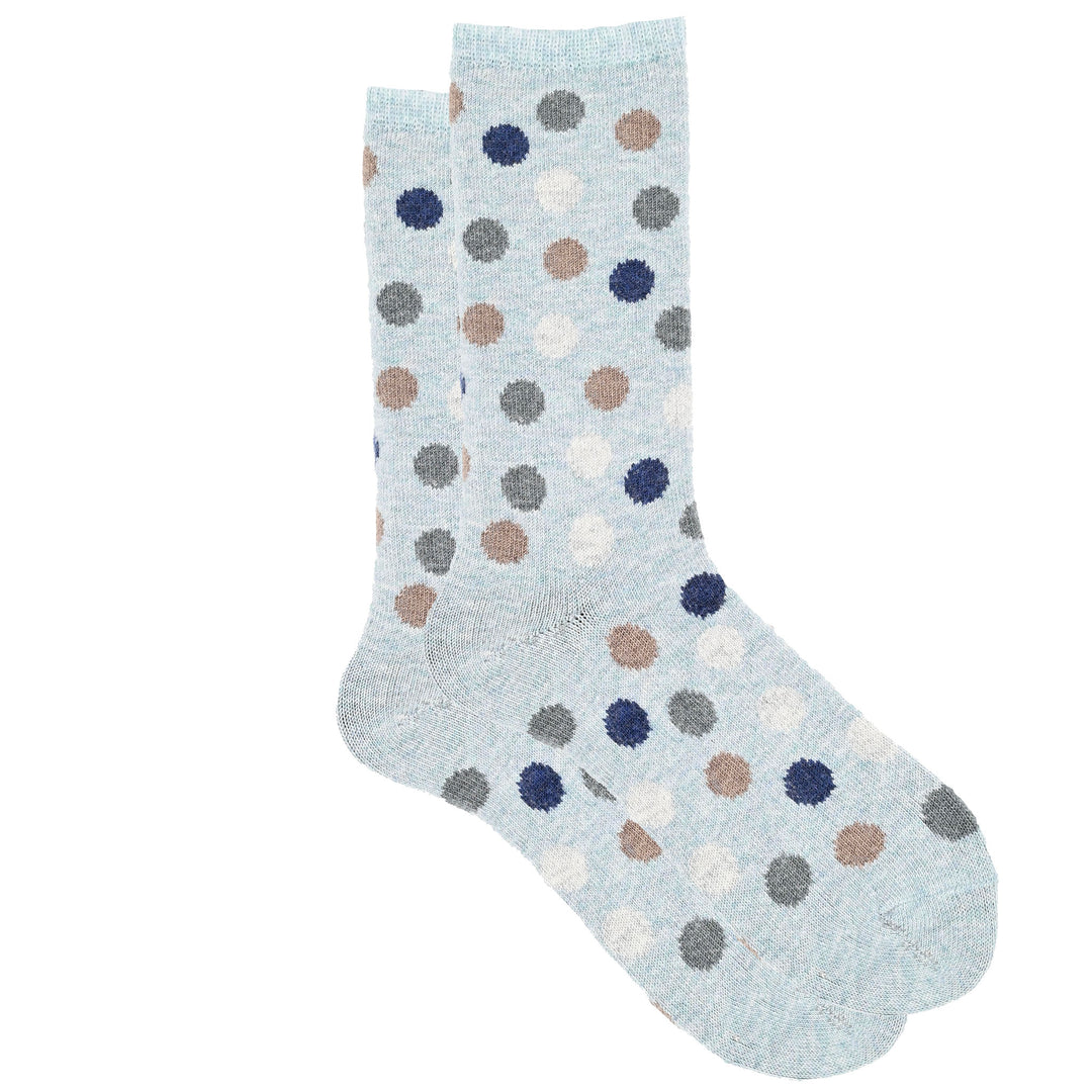 A pair of lightblue crew socks with a multicolored dot pattern.