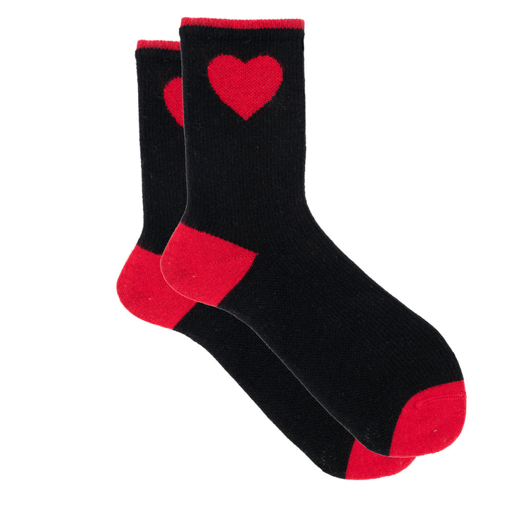 Black socks with red hearts and cuffs on a white background