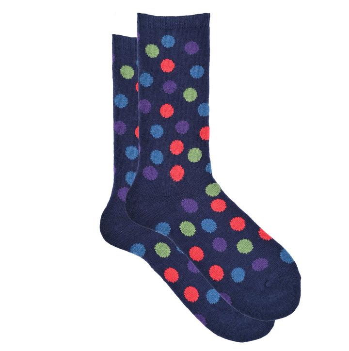 A pair of blue crew socks with a multicolored dot pattern.