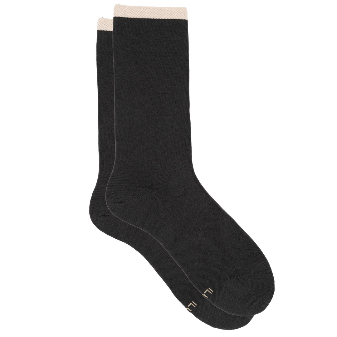 Pair of black socks with beige accents on a white background
