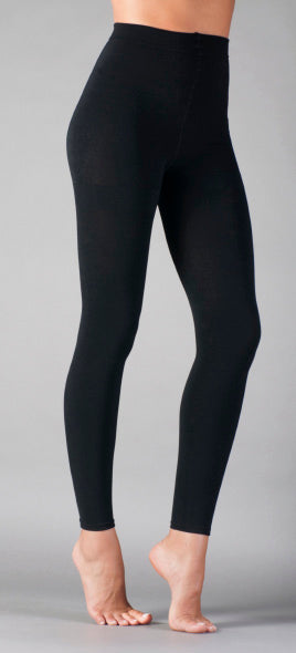 Black leggings worn by a person on a gray background