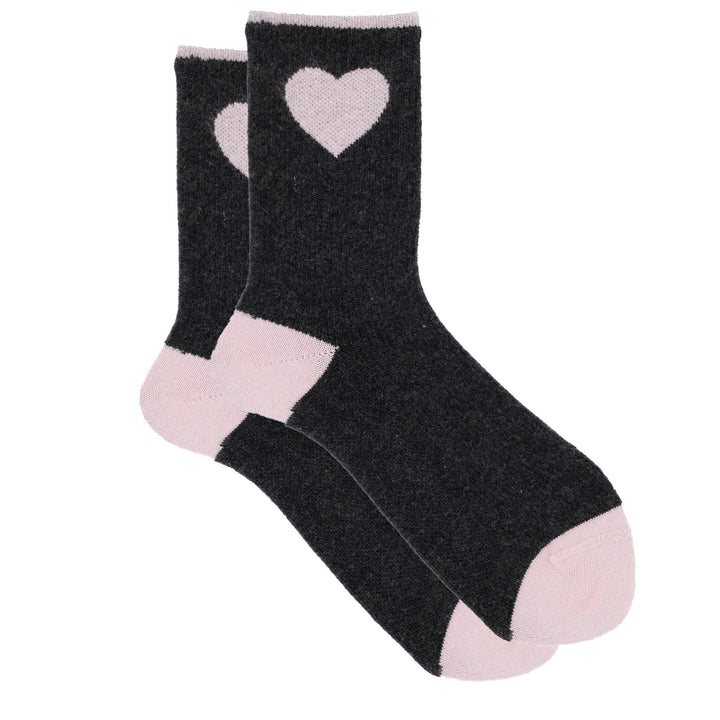 Black socks with pink hearts and cuffs on a white background